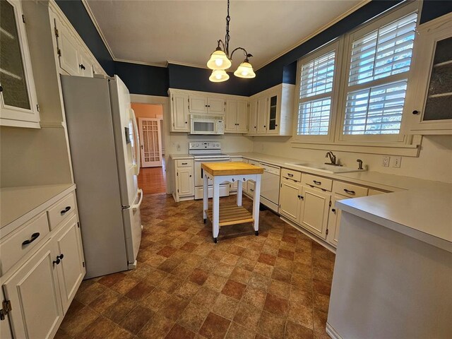 804 N Willow St, Pauls Valley, OK 73075 - kitchen with light countertops, a sink, ornamental molding, and white appliances