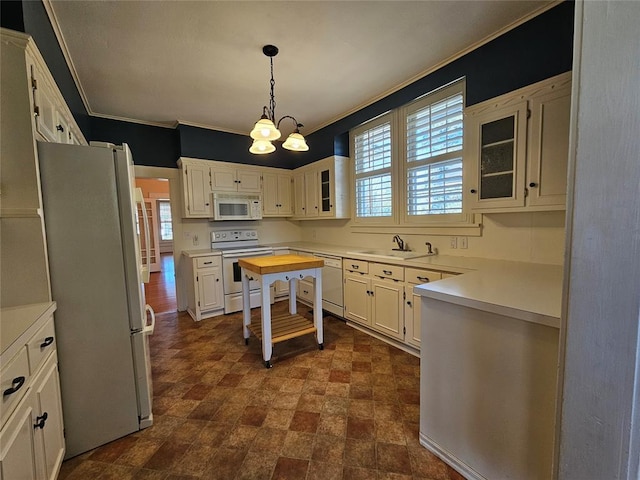 804 N Willow St, Pauls Valley, OK 73075 - kitchen with glass insert cabinets, light countertops, a sink, and white appliances