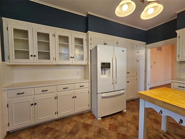 804 N Willow St, Pauls Valley, OK 73075 - kitchen with glass insert cabinets, white cabinetry, and white refrigerator with ice dispenser