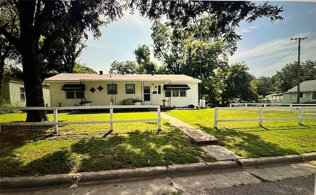 view of front of house with a fenced front yard and a front lawn