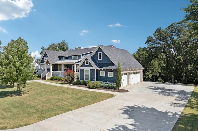 craftsman-style home with an attached garage, covered porch, concrete driveway, board and batten siding, and a front yard