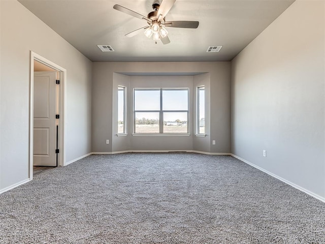 unfurnished room featuring baseboards, visible vents, and carpet flooring