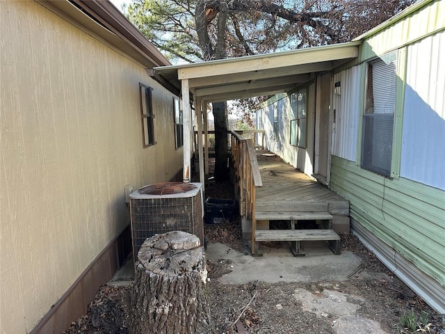 view of home's exterior with central air condition unit and a deck