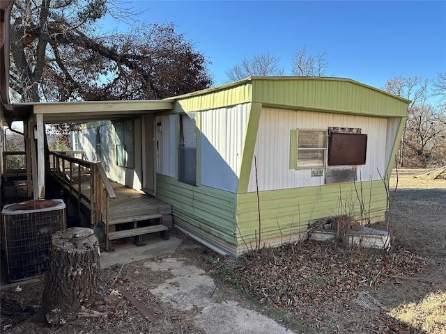 view of side of property featuring central AC and a wooden deck