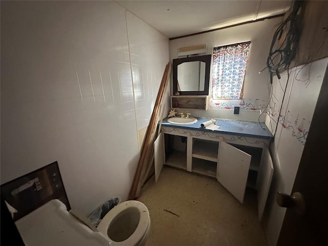 bathroom featuring toilet and vanity