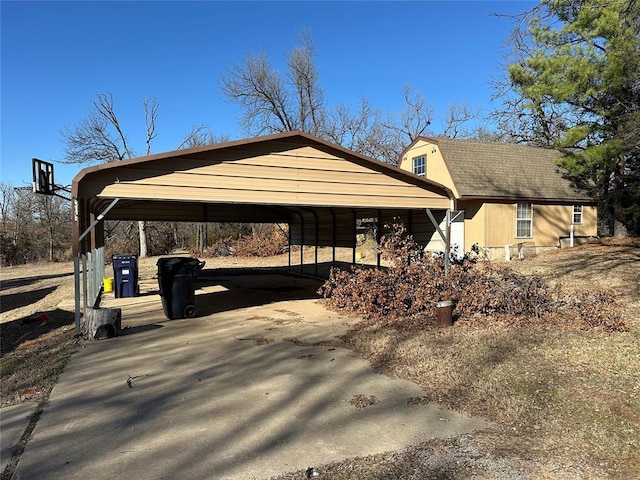 view of car parking featuring driveway and a carport