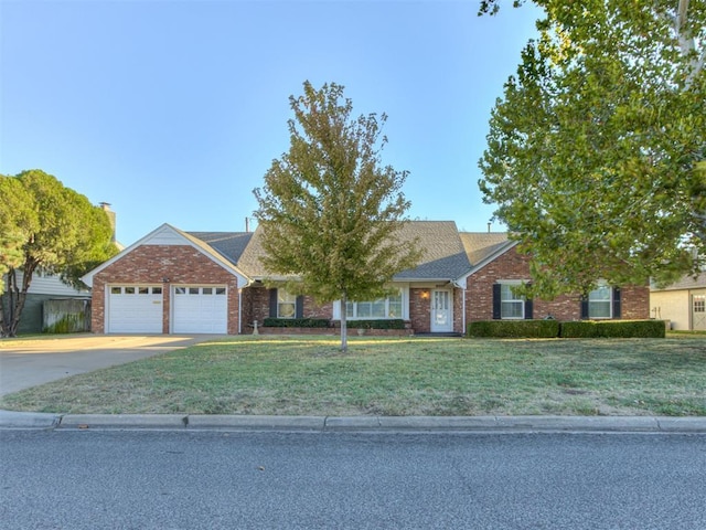 ranch-style house featuring an attached garage, brick siding, driveway, and a front yard