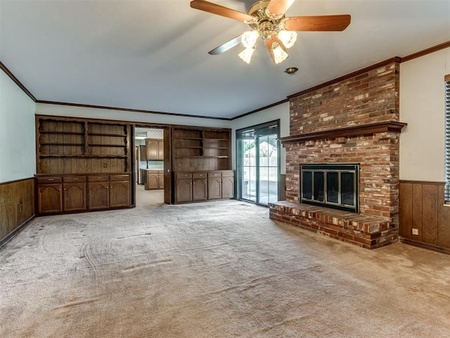 unfurnished living room with wainscoting, carpet flooring, and wooden walls