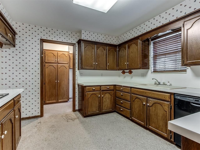 kitchen with black dishwasher, light countertops, a sink, and wallpapered walls