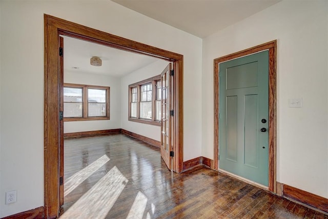 entrance foyer with dark wood-style floors and baseboards