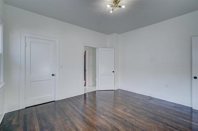 unfurnished bedroom with baseboards and wood finished floors