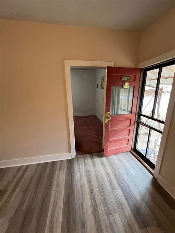 interior space with wood finished floors and baseboards