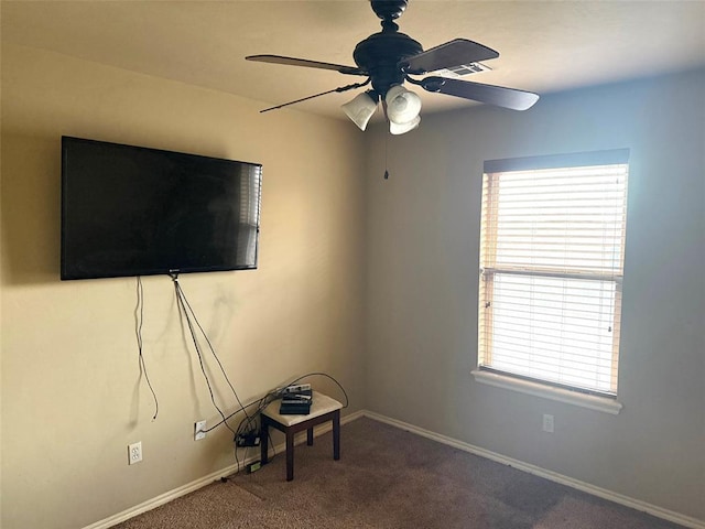 interior space featuring carpet floors, ceiling fan, and baseboards