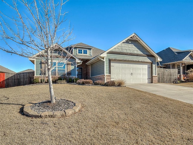 view of front of house featuring concrete driveway, brick siding, an attached garage, and fence