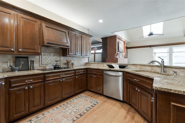 kitchen with a sink, plenty of natural light, black electric stovetop, and dishwasher