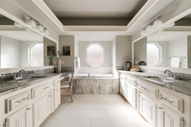 bathroom with a healthy amount of sunlight, a sink, and a garden tub