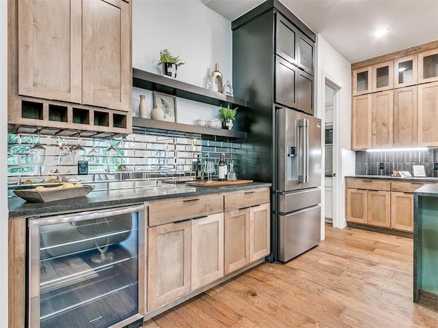 kitchen featuring beverage cooler, high end fridge, light brown cabinets, and light wood-style flooring