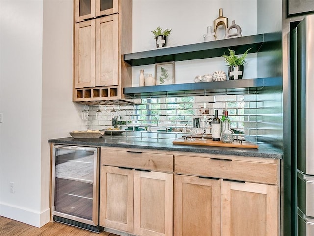 bar with wine cooler, bar area, baseboards, light wood-style floors, and tasteful backsplash