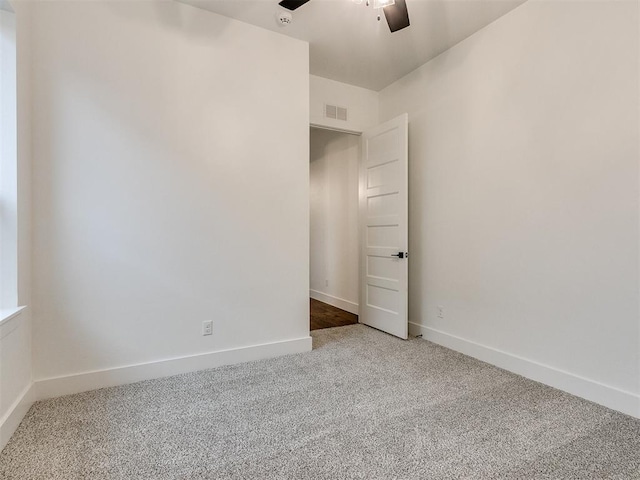 unfurnished bedroom featuring a ceiling fan, baseboards, visible vents, and carpet flooring