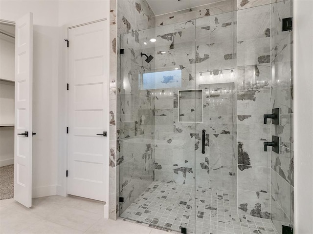 bathroom with a stall shower and tile patterned floors