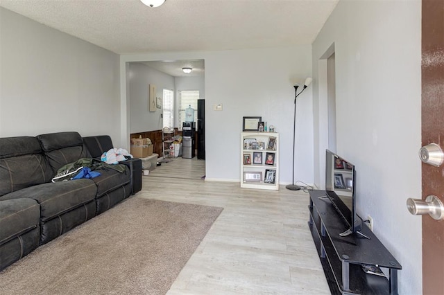 living room featuring baseboards and light wood-type flooring