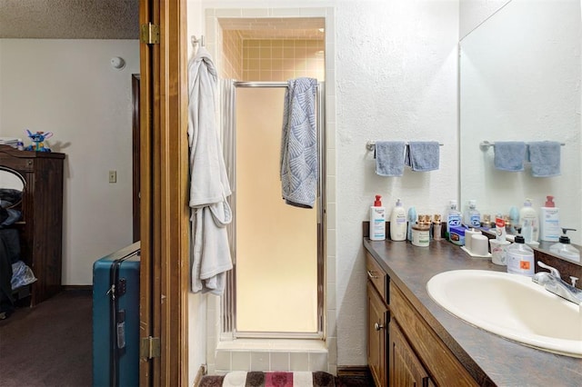 bathroom with vanity and a shower stall