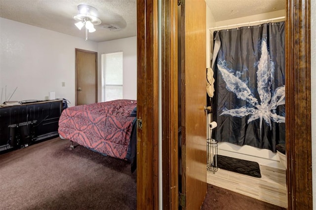 carpeted bedroom featuring a ceiling fan, a textured ceiling, and visible vents