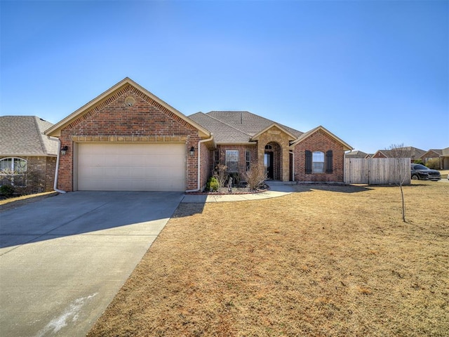 single story home with brick siding, concrete driveway, an attached garage, fence, and a front lawn