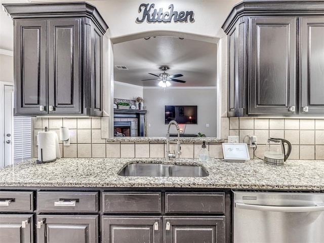 kitchen featuring ornamental molding, stainless steel dishwasher, a sink, and visible vents