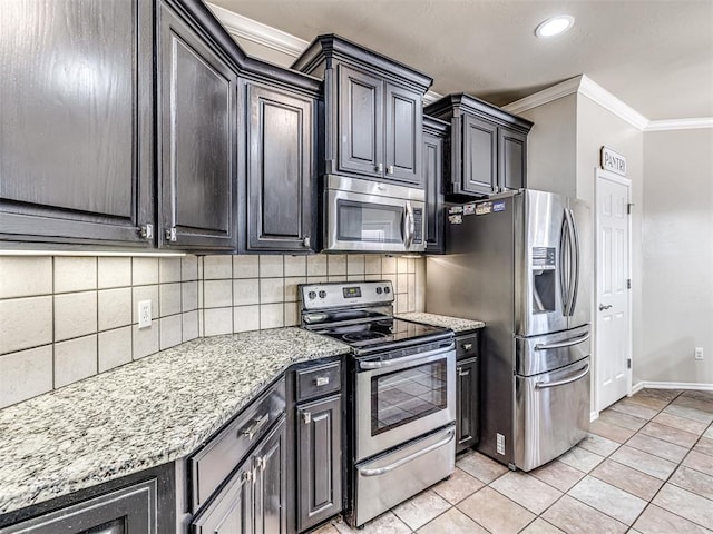 kitchen featuring light tile patterned floors, light stone counters, ornamental molding, appliances with stainless steel finishes, and backsplash