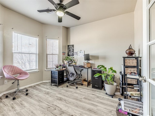 home office featuring a ceiling fan, baseboards, and wood finished floors