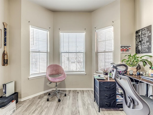 office with light wood-type flooring and baseboards