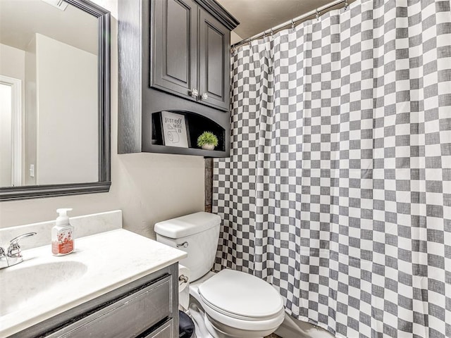 bathroom with a shower with shower curtain, vanity, and toilet