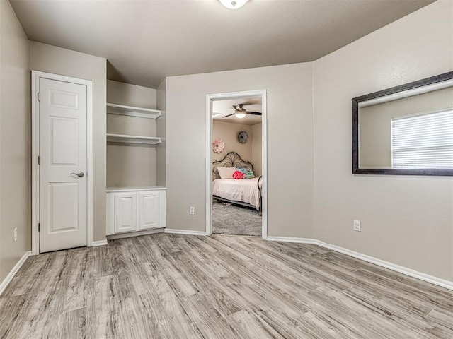 unfurnished bedroom with light wood-type flooring and baseboards