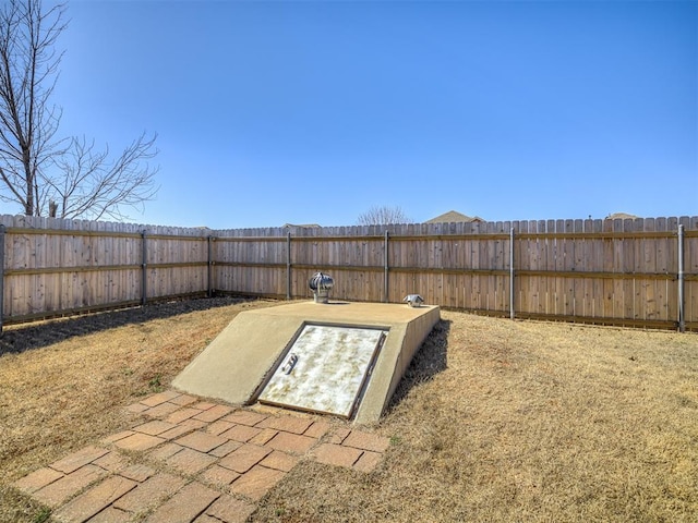 view of storm shelter with a fenced backyard