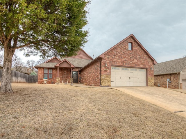 view of front of house featuring concrete driveway, an attached garage, fence, and brick siding