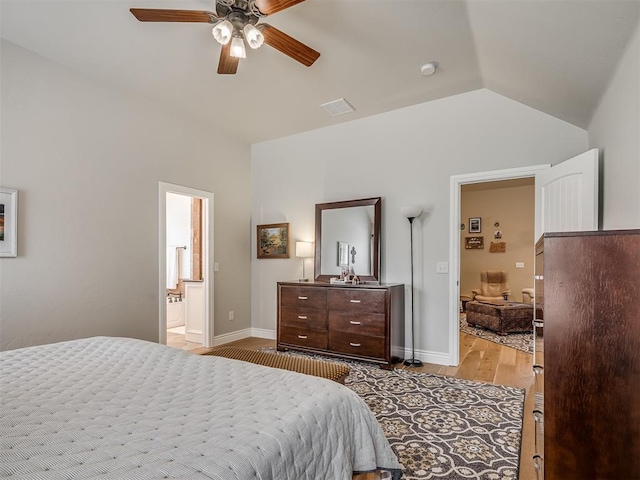 bedroom featuring baseboards, lofted ceiling, a ceiling fan, and light wood finished floors