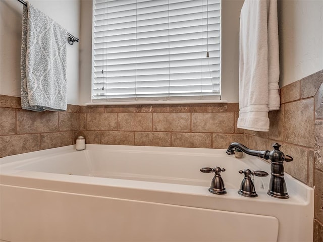 full bathroom with a bath and plenty of natural light