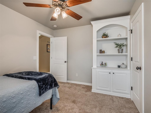 bedroom with light colored carpet, baseboards, and a ceiling fan