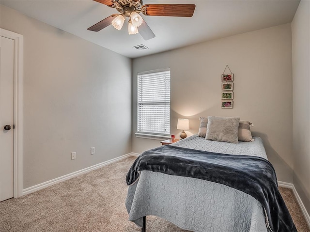 carpeted bedroom with visible vents, ceiling fan, and baseboards