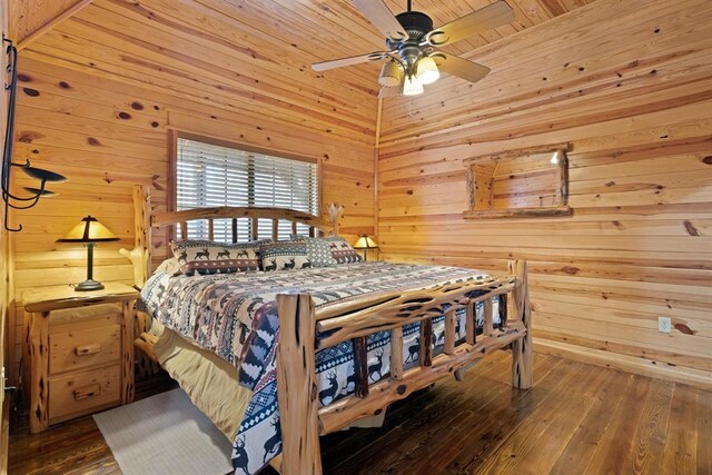 bedroom with a ceiling fan, wooden walls, wood ceiling, and wood-type flooring