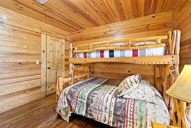 bedroom featuring wood ceiling, wooden walls, and wood finished floors