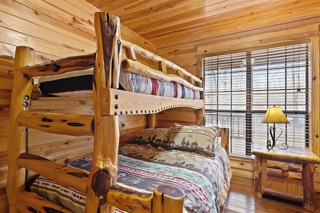 bedroom with wood ceiling, wood walls, and hardwood / wood-style flooring