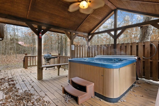 wooden deck featuring fence and a hot tub