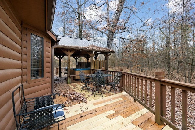 deck with a gazebo and outdoor dining space