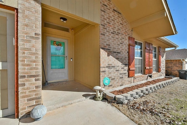 property entrance with brick siding