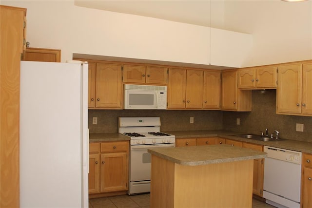 kitchen featuring white appliances, tasteful backsplash, a center island, a sink, and light tile patterned flooring