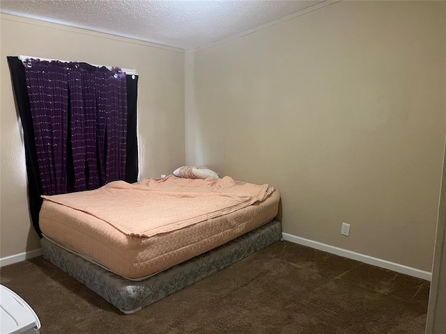 carpeted bedroom featuring a textured ceiling and baseboards