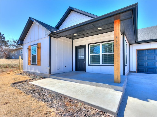 view of front of house with board and batten siding and roof with shingles