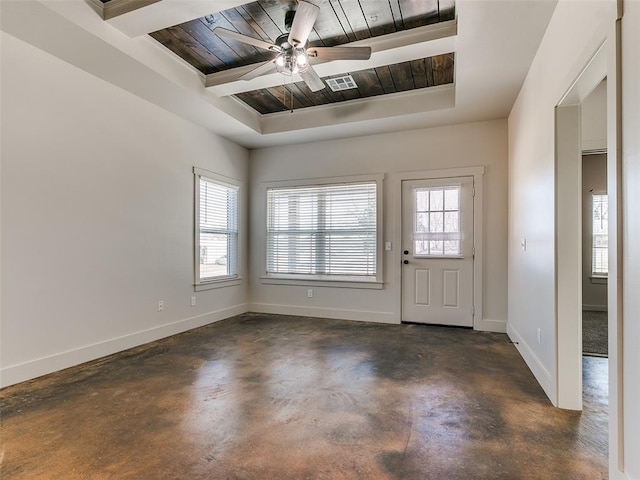 foyer entrance with wood ceiling, a wealth of natural light, a raised ceiling, and baseboards